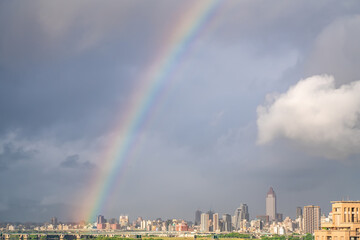 Skyline of taipei city in downtown Taipei, Taiwan.bright sun shining center top and a large rainbow