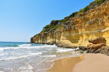 Fototapeta na wymiar Beach on the golden coast of Tarragona, small waves and fine golden sand.
