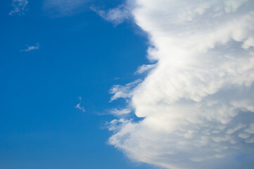 Sky is splitted into clear blue sky and cloudy sky with cloud. Diverse and varied weather. 
