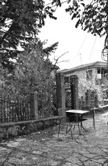 Table for two in the central square of the village (black & white)