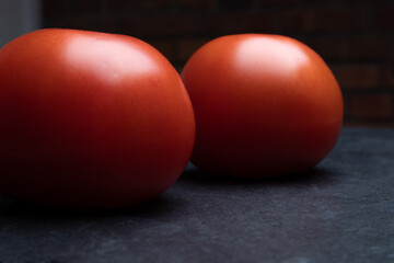 Fototapeta na wymiar Beautiful natural tomatoes on a black background