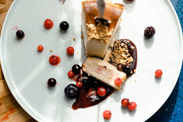 High view of a homemade cheesecake portion and berries
