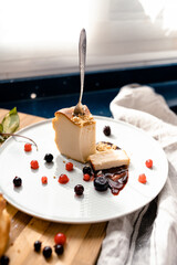 A homemade cheesecake portion and berries