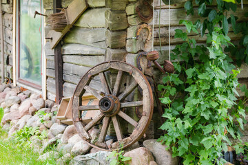 Old wooden wheel in willage near old wodden house in Lithuania Europe