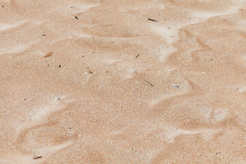 Closeup of sand pattern of a beach in the summer