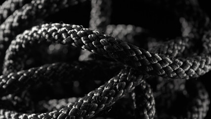 The black rope lies chaotically on a black background.