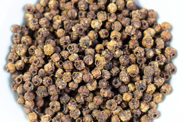 Ripe dry hawthorn berries on white plate