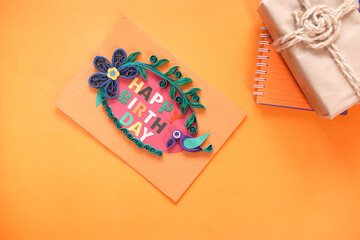 top view of birthday card on orange background