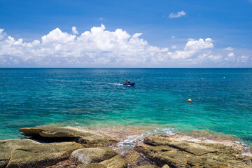 Fototapeta na wymiar a fishing boat rides the turquoise sea