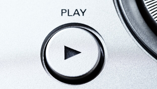 A movie playback button on a control panel and selector switch. Selective focus.