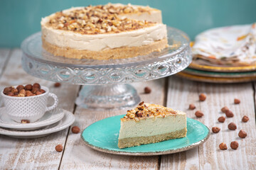 Cheese cake with hazelnuts on wood background