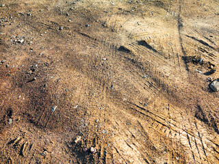 Traces of off-road tires. Cracked earth on country road with traces of tires, cars, cracks and...