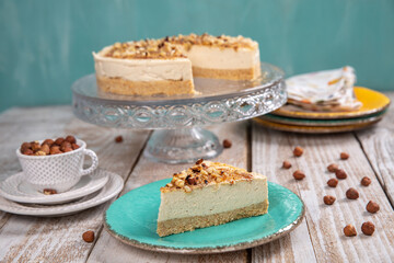 Cheese cake with hazelnuts on wood background