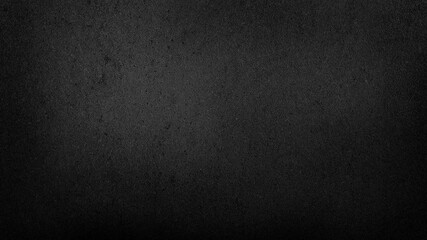 grunge dark black gradient stucco wall background. abstract grainy black wall background with space...