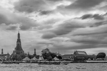 Beautiful view of the famous Buddhist Temple of Dawn, Wat Arun, on the Chao Phraya River, against a dramatic sky, Bangkok, Thailand