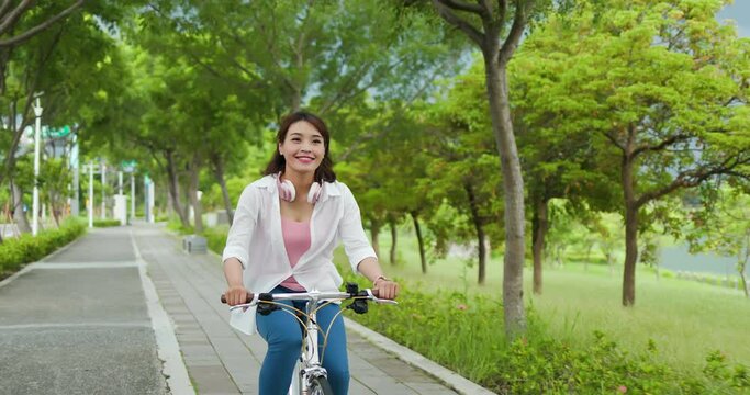 Asian female ride bicycle
