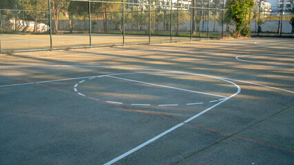 part of hard surface baskeball playground in public park or school
