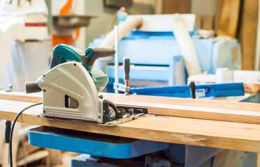 Professional circular saw on a board in a carpentry workshop