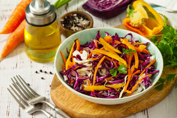 Cole Slaw. Cabbage salad in a bowl on a wooden table.