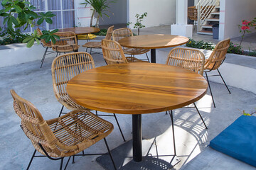 Wooden Table & wicker rattan chair in cafe restaurant