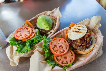 Large appetizing Hawaiian burger with bacon, onion on a beef patty