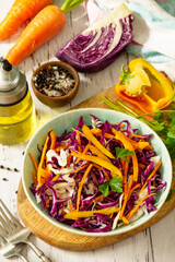 Cole Slaw. Cabbage salad in a bowl on a wooden table.
