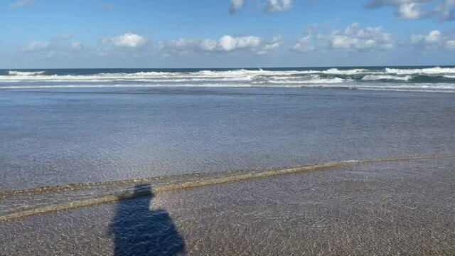 Shadow Of A Female Photographer At The Beach