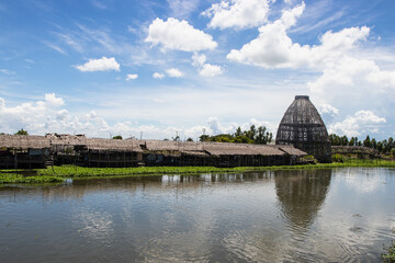 Biggest coop made from the bamboo structure is a trap for catching fish at Saphanburi Arch bridge local Market, Thailand.