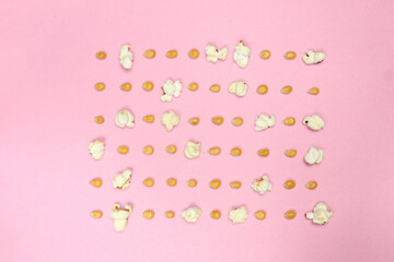 pop corn seeds symmetric on pink paper