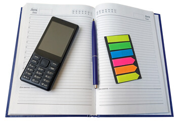 Notebook, pen and cellular telephone on a white