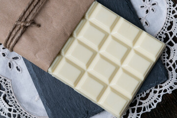 White chocolate tablet on rustic background