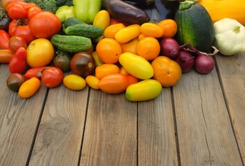 Many different non-starchy vegetables on a wooden background. Harvest and summer season concept.