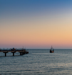 silhouette of an old Viking ship saling off into the sunset on the Baltic Sea