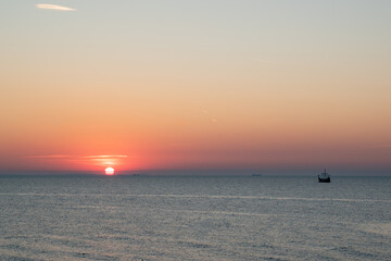 silhouette of an old Viking ship saling off into the sunset on the Baltic Sea