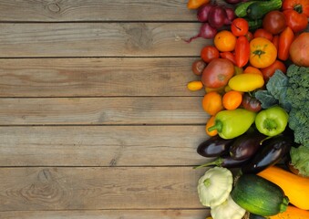 Many different bright, colorful vegetables on a wooden background. Harvest and summer season concept.