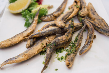 
Plate of fried anchovies in batter with lemon and parsley
Delicious fish typical gastronomic dish of the Mediterranean coast
