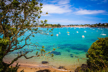 Small bay with boats at the emerald coast in Brittany, France