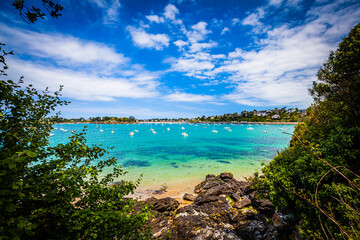 Fototapeta na wymiar Small bay with boats at the emerald coast in Brittany, France