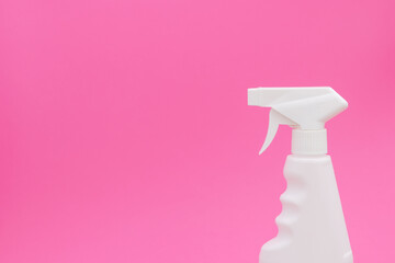 Cleaning spray on a pink background.