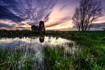 derelict windmill at sunset and interesting cloud formations