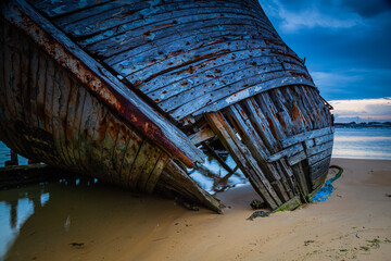 Old shipwrecks at the ship cemetary at river Etel in Brittany, France