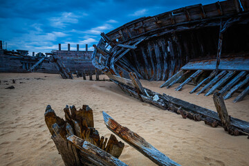 Old shipwrecks at the ship cemetary at river Etel in Brittany, France
