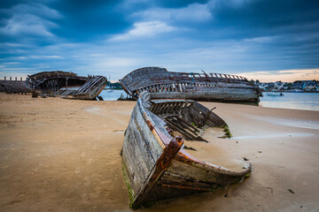 Old shipwrecks at the ship cemetary at river Etel in Brittany, France