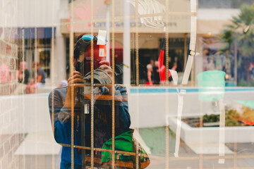 photographer reflection on a storefront 