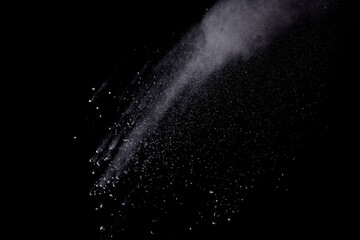 Freeze motion of white color powder exploding on dark background. 