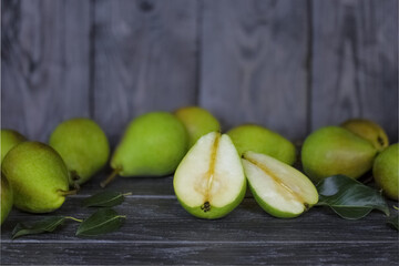 ripe pears are scattered on the table. close-up of pears. the crop of pears. pears on a wooden background.
