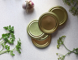 Tin lids for canning with herbs, close-up, top view