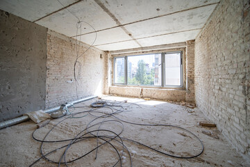 Empty unfinished interior with natural light. Hotel apartment construction 