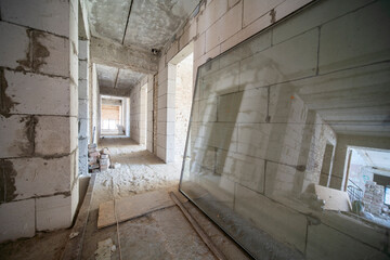 Empty unfinished interiors. Replacement of windows during the construction of the hotel - 374378291