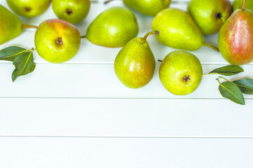 ripe pears are scattered on the table. background with green pears. green pears on a white background.